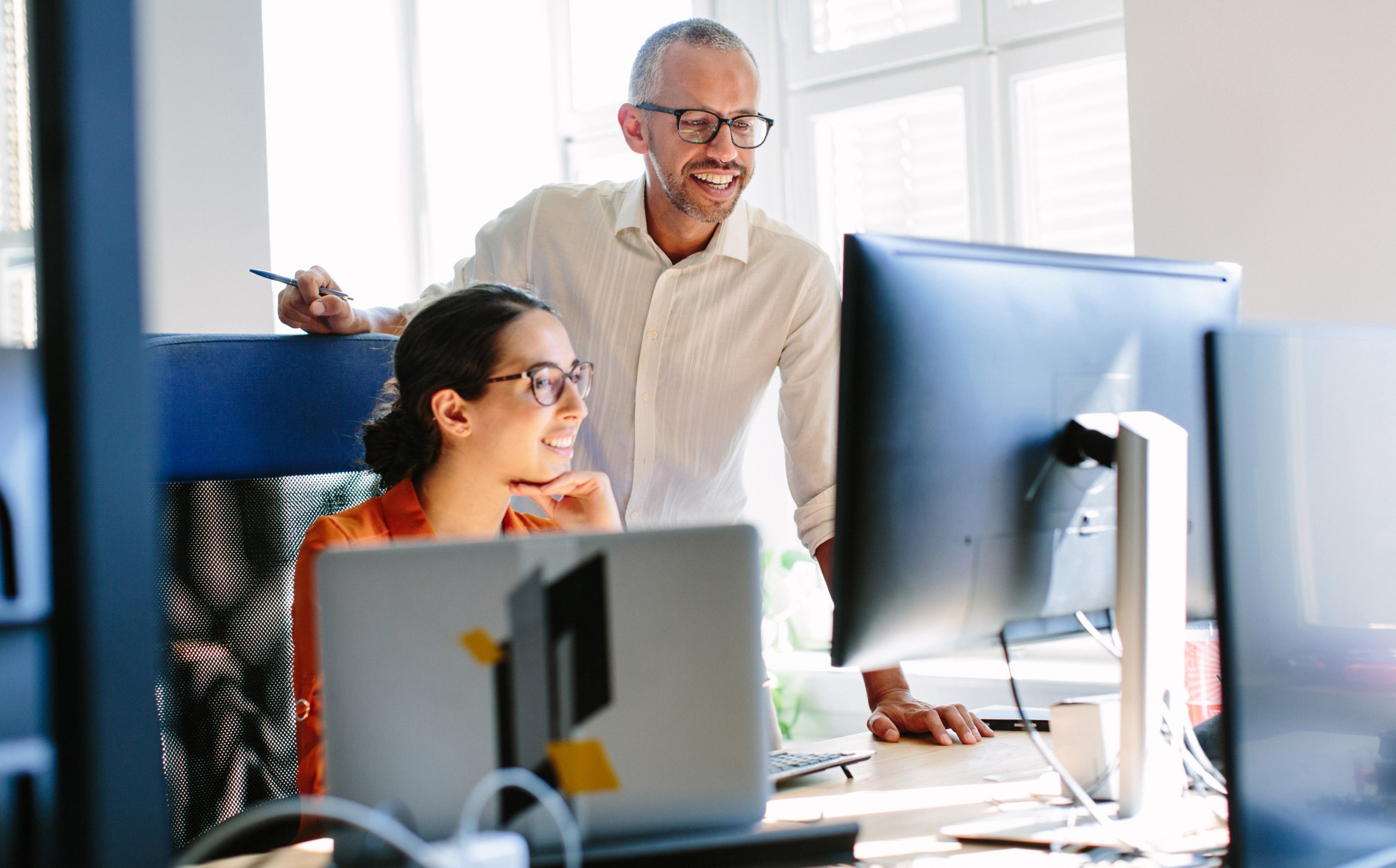Two developers reviewing an AI software development project.