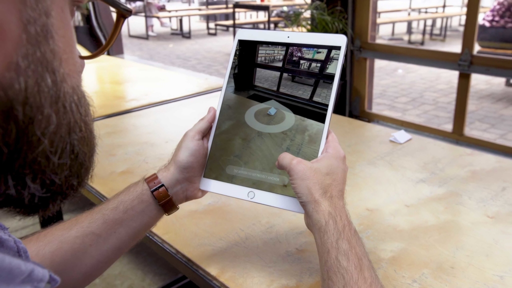 Man using AR App on iPad